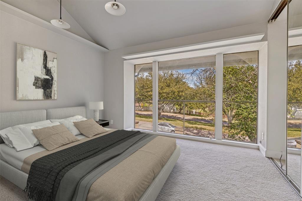 4505 North O'Connor Road, Unit 1121 Irving, TX 75062 - Photo 22 of 34 a bedroom with a large bed and a large window