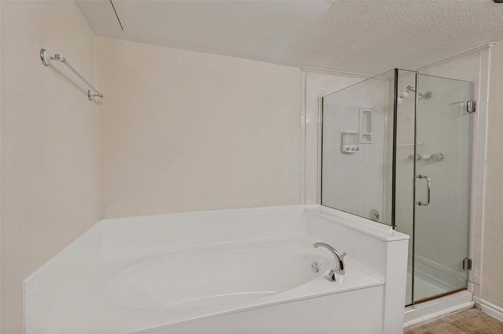 4505 North O'Connor Road, Unit 1121 Irving, TX 75062 - Photo 26 of 34 a white bath tub sitting next to a shower