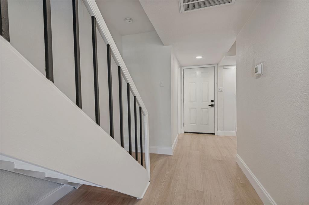 4505 North O'Connor Road, Unit 1121 Irving, TX 75062 - Photo 3 of 34 a view of a hallway with wooden floor and staircase