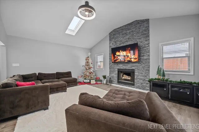 a living room with furniture a fireplace and a flat screen tv