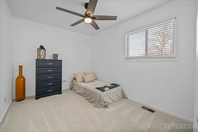 a bedroom with a bed and a ceiling fan