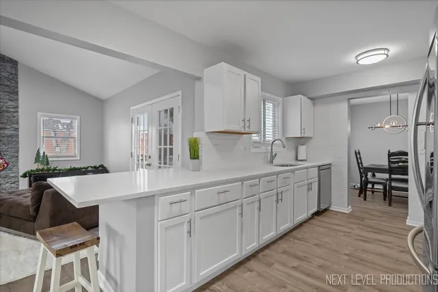 a kitchen with center island table and chairs