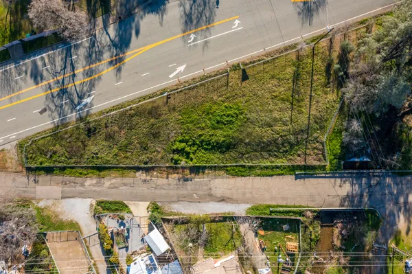 an aerial view of residential houses with outdoor space