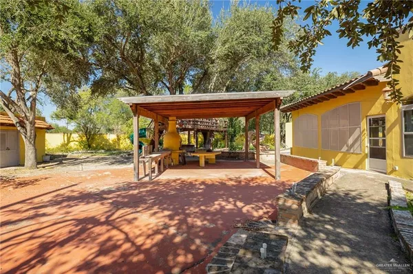 a view of a patio with table and chairs with wooden fence and floor