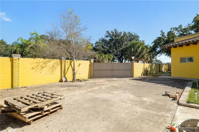 a view of small yard with large trees