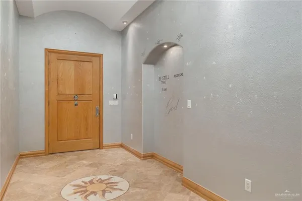 an empty room with windows and closet