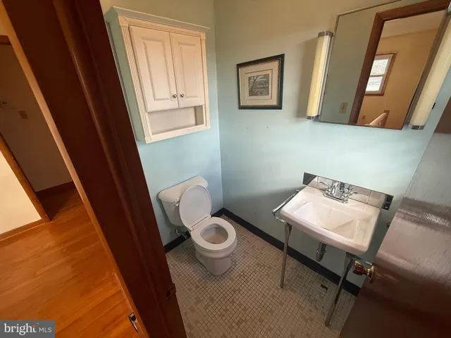 a bathroom with a toilet and a mirror