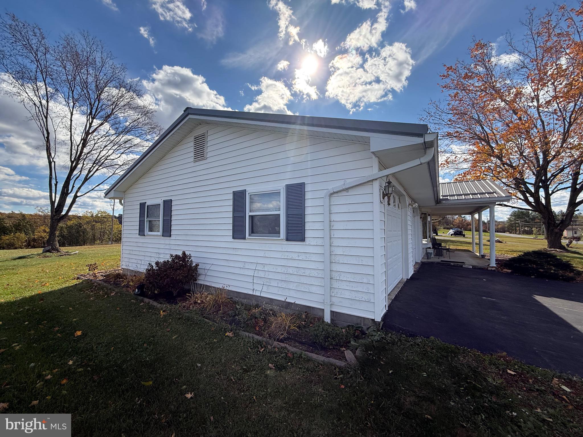 384 Fairview Drive Berkeley Springs, WV 25411 - Photo 2 of 24 a front view of a house with garden