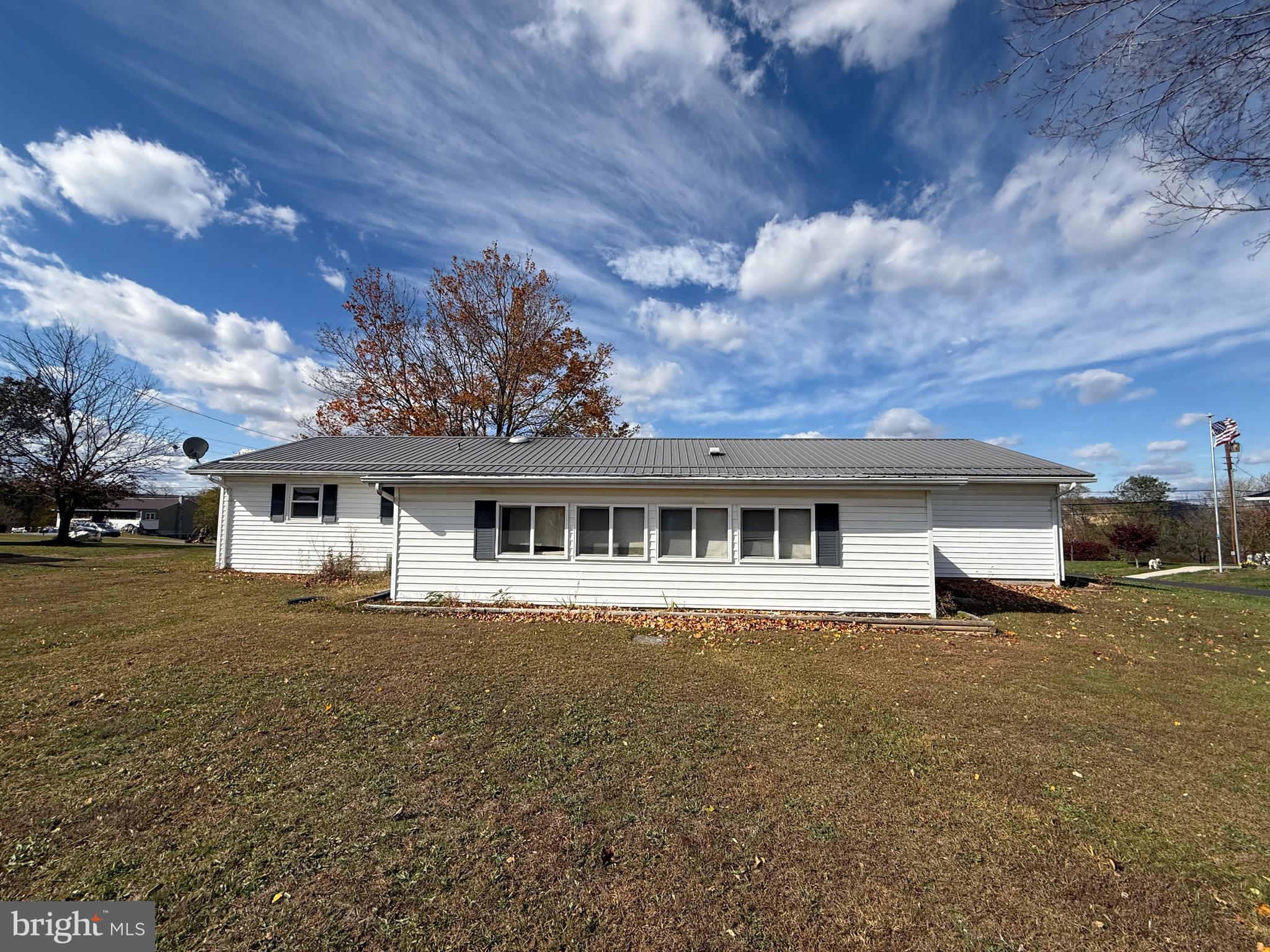 384 Fairview Drive Berkeley Springs, WV 25411 - Photo 4 of 24 a front view of house with yard and trees around