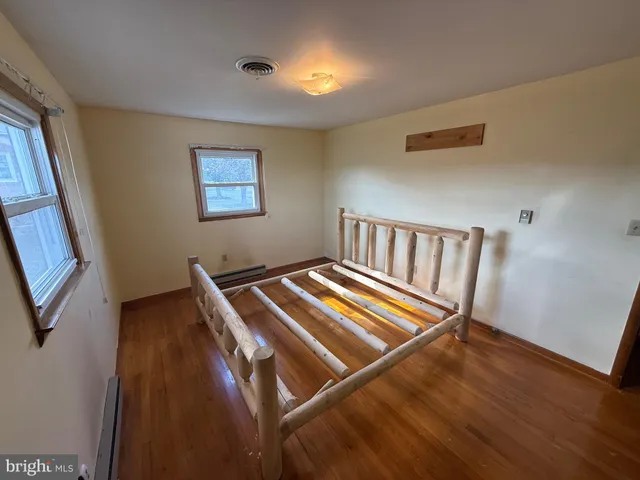 a view of room with window and wooden floor