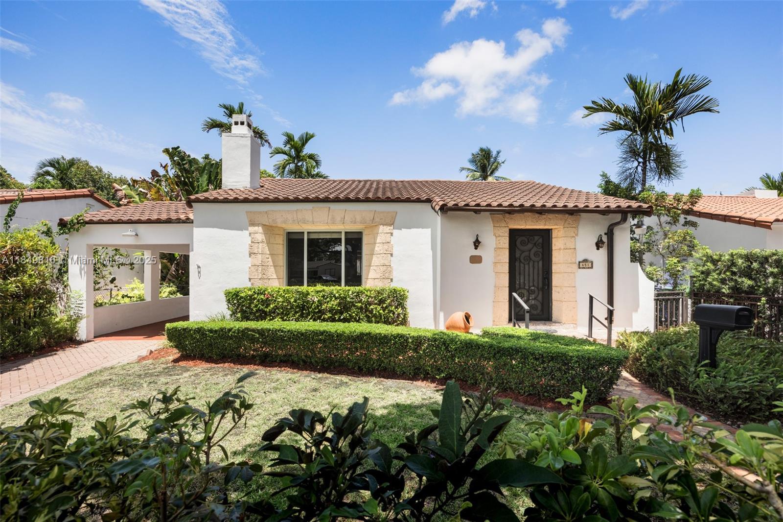 a front view of a house with a garden