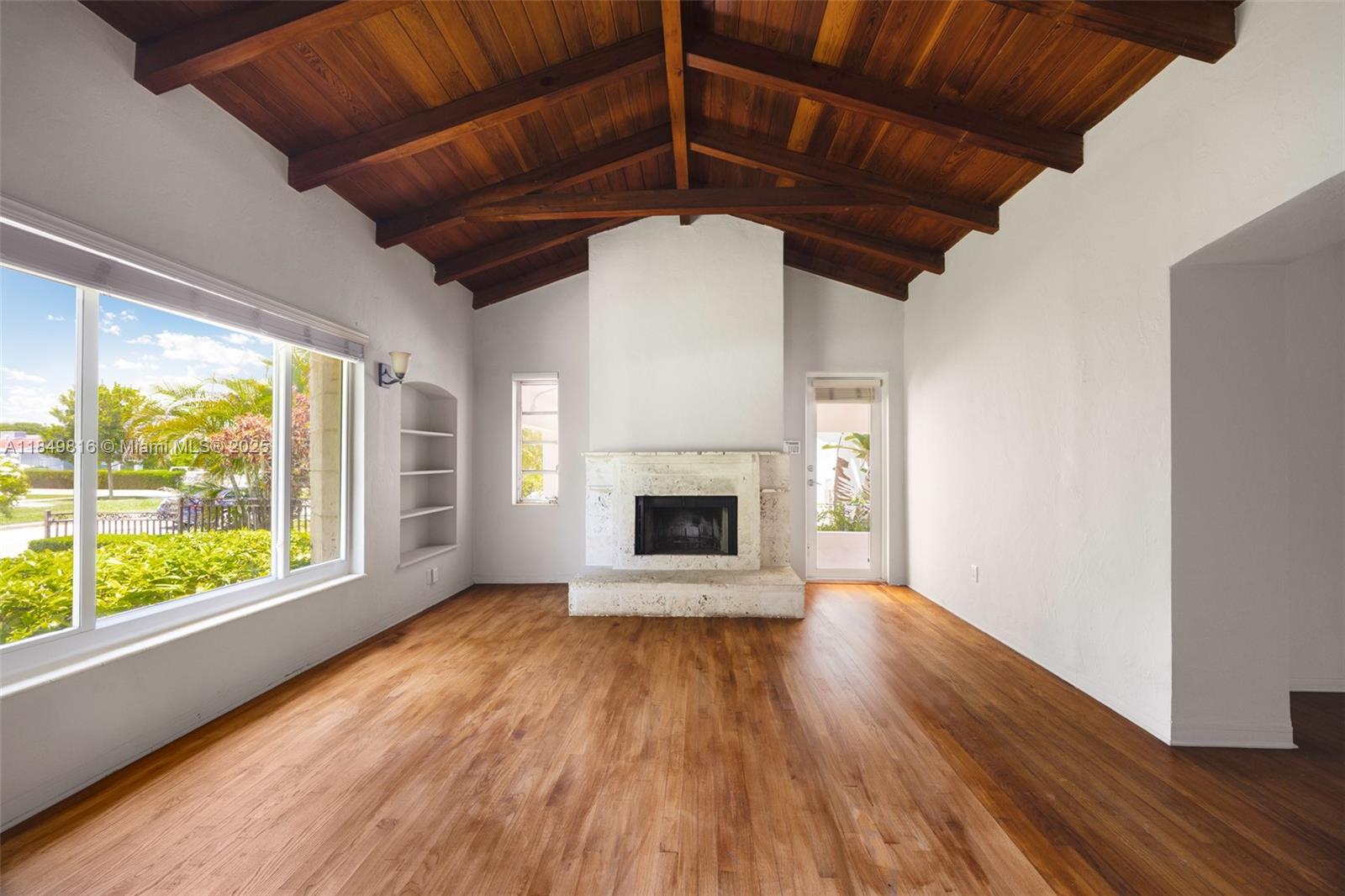 451 Southwest 25th Road Miami, FL 33129 - Photo 13 of 25 a view of empty room with wooden floor and fireplace