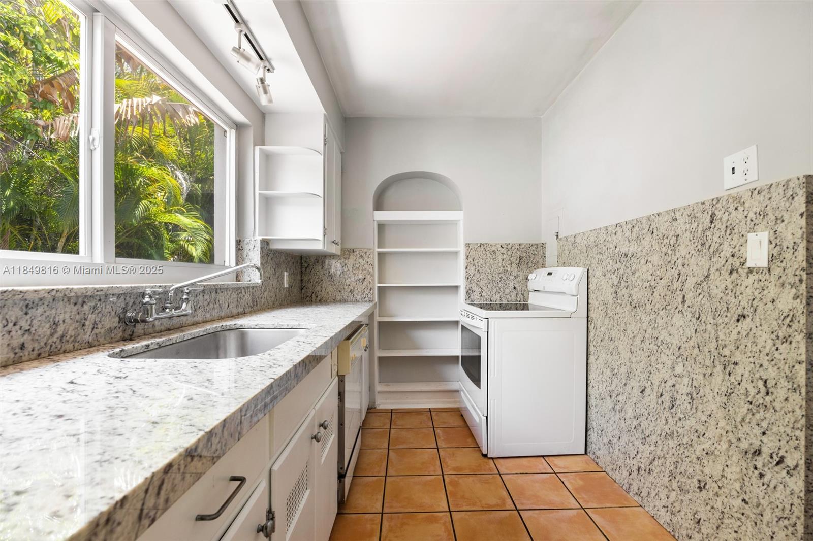 451 Southwest 25th Road Miami, FL 33129 - Photo 15 of 25 a kitchen with a cabinets and a stove