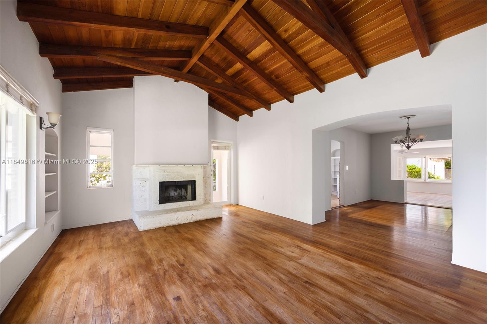451 Southwest 25th Road Miami, FL 33129 - Photo 6 of 25 a view of empty room with wooden floor and fireplace