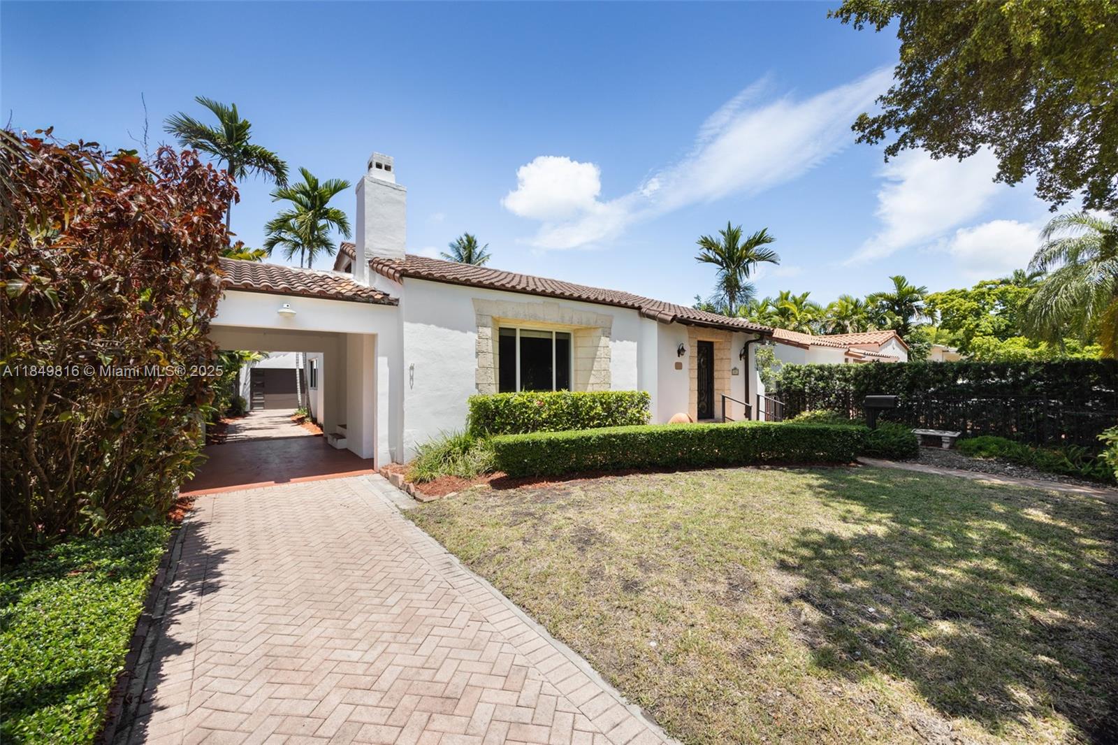 451 Southwest 25th Road Miami, FL 33129 - Photo 10 of 25 front view of a house with a yard and potted plants
