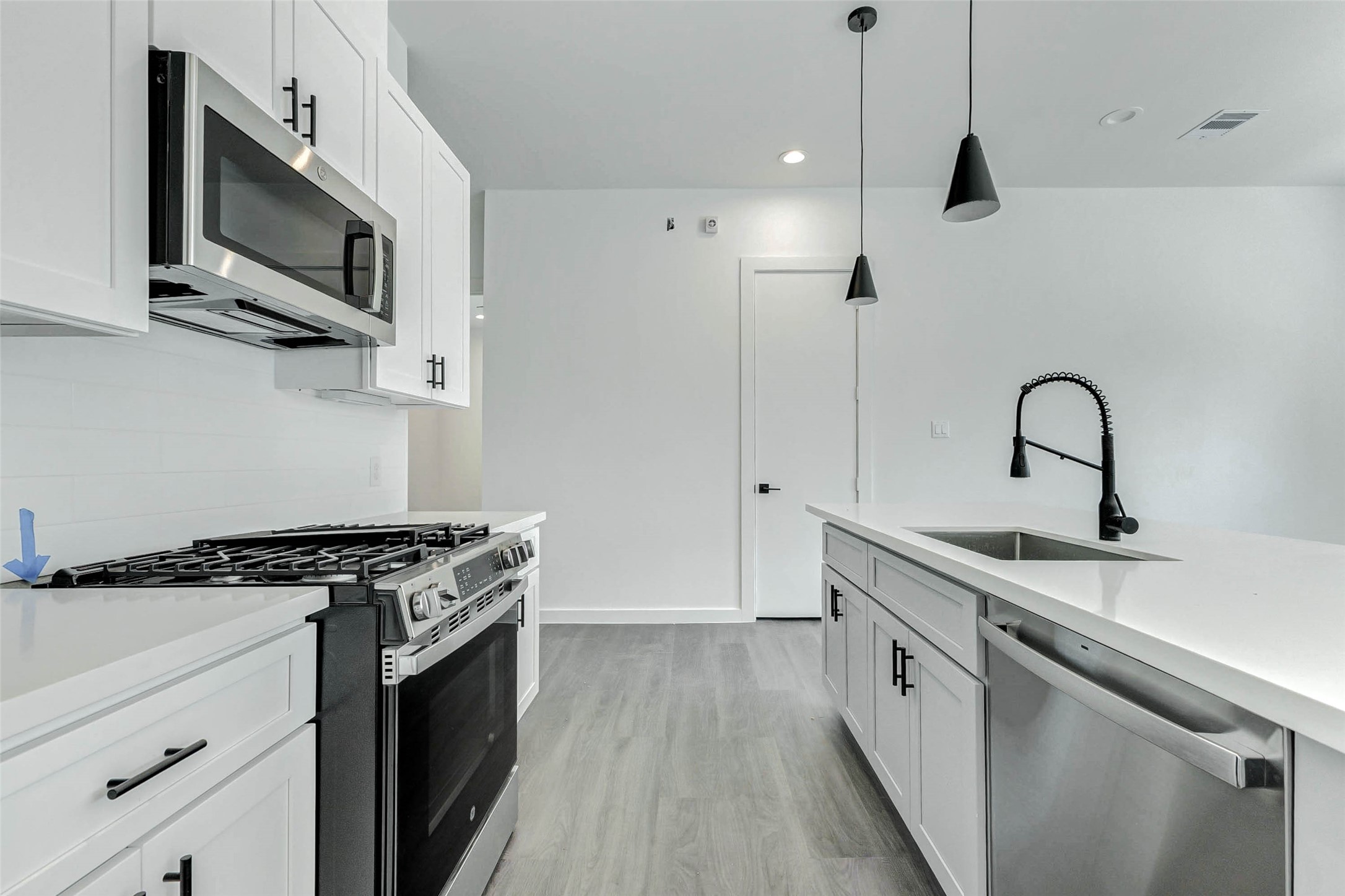 6017 Beall Street Houston, TX 77091 - Photo 13 of 33 A chef’s dream setup with a gas range, built-in microwave, and quartz workspace! The open layout and functional island allow cooking and connection to go hand-in-hand in this contemporary kitchen.