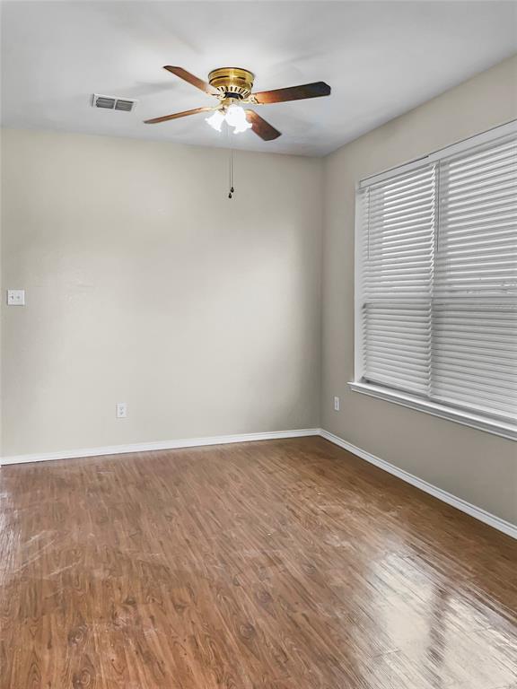 213 Long Prairie Drive Forney, TX 75126 - Photo 4 of 14 a view of an empty room with a window and wooden floor