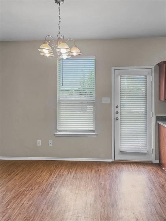 213 Long Prairie Drive Forney, TX 75126 - Photo 7 of 14 a view of empty room with wooden floor and fan