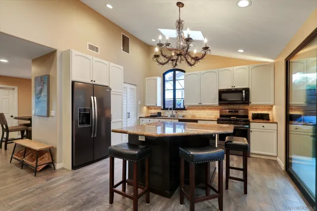 a view of a dining room with furniture wooden floor and chandelier