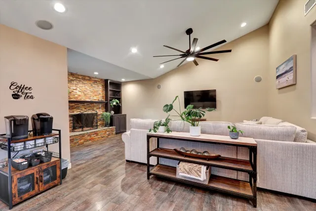 a living room with furniture a flat screen tv and a wall painting