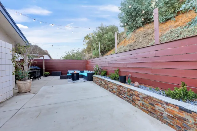 a view of a chair and table in the backyard