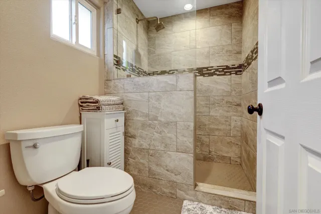 a bathroom with a toilet and shower