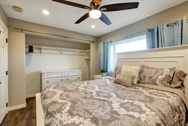 a bedroom with a large bed and a chandelier