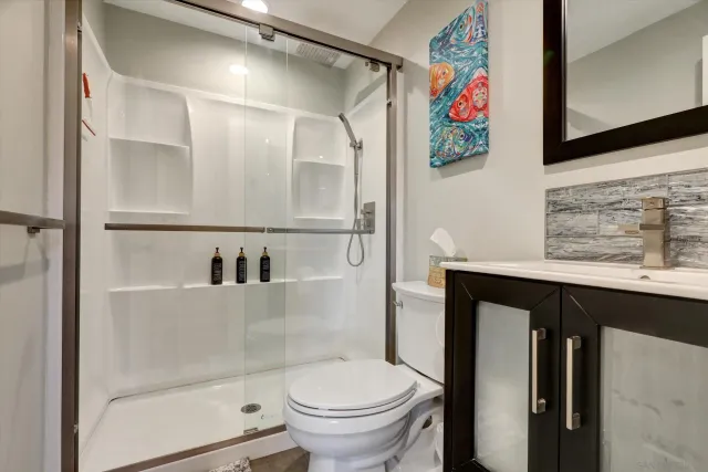 a bathroom with a toilet and a shower