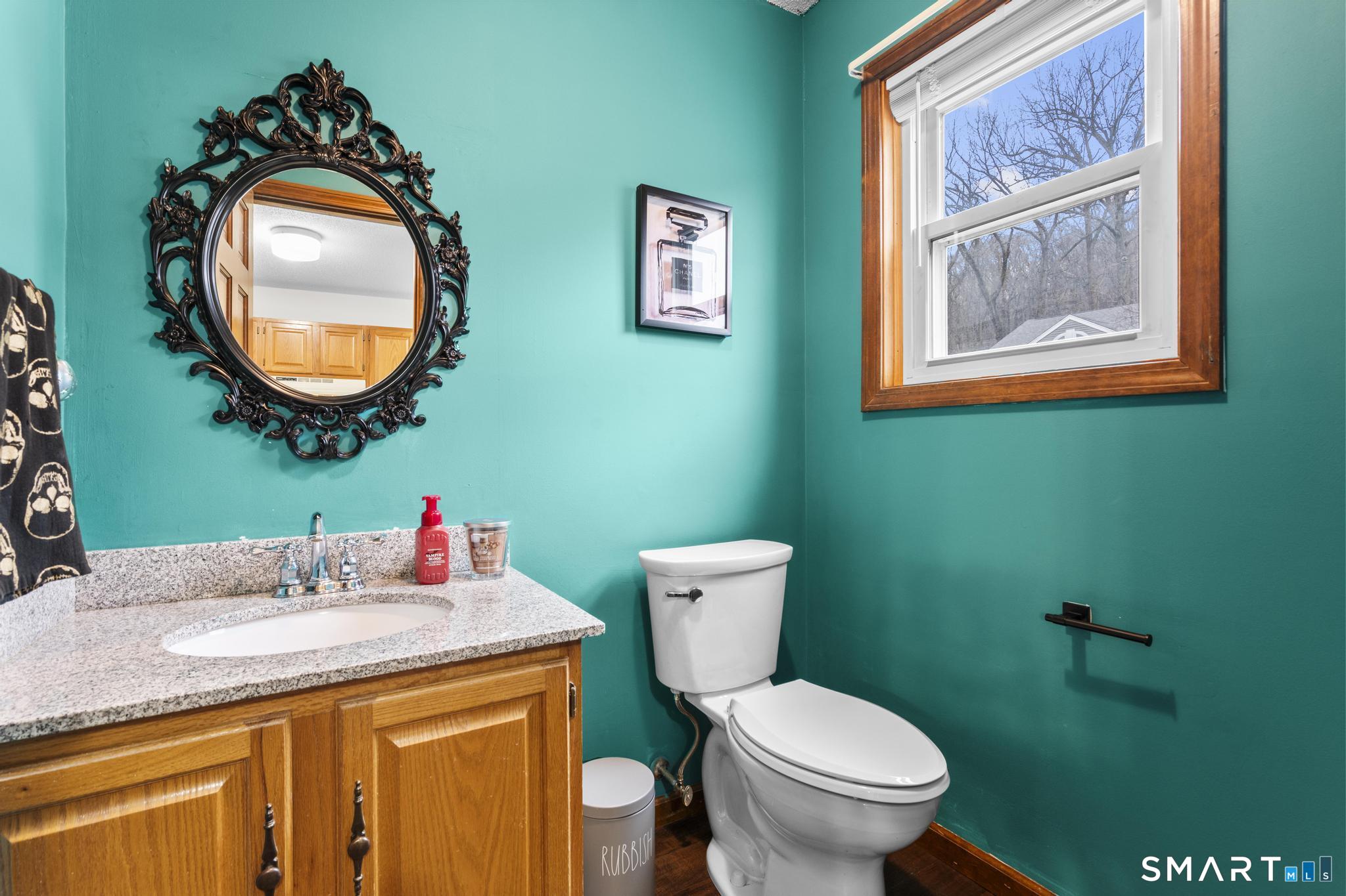 1655 North Colony Road, Unit 15 Meriden, CT 06450 - Photo 11 of 25 a bathroom with a toilet a sink and a mirror
