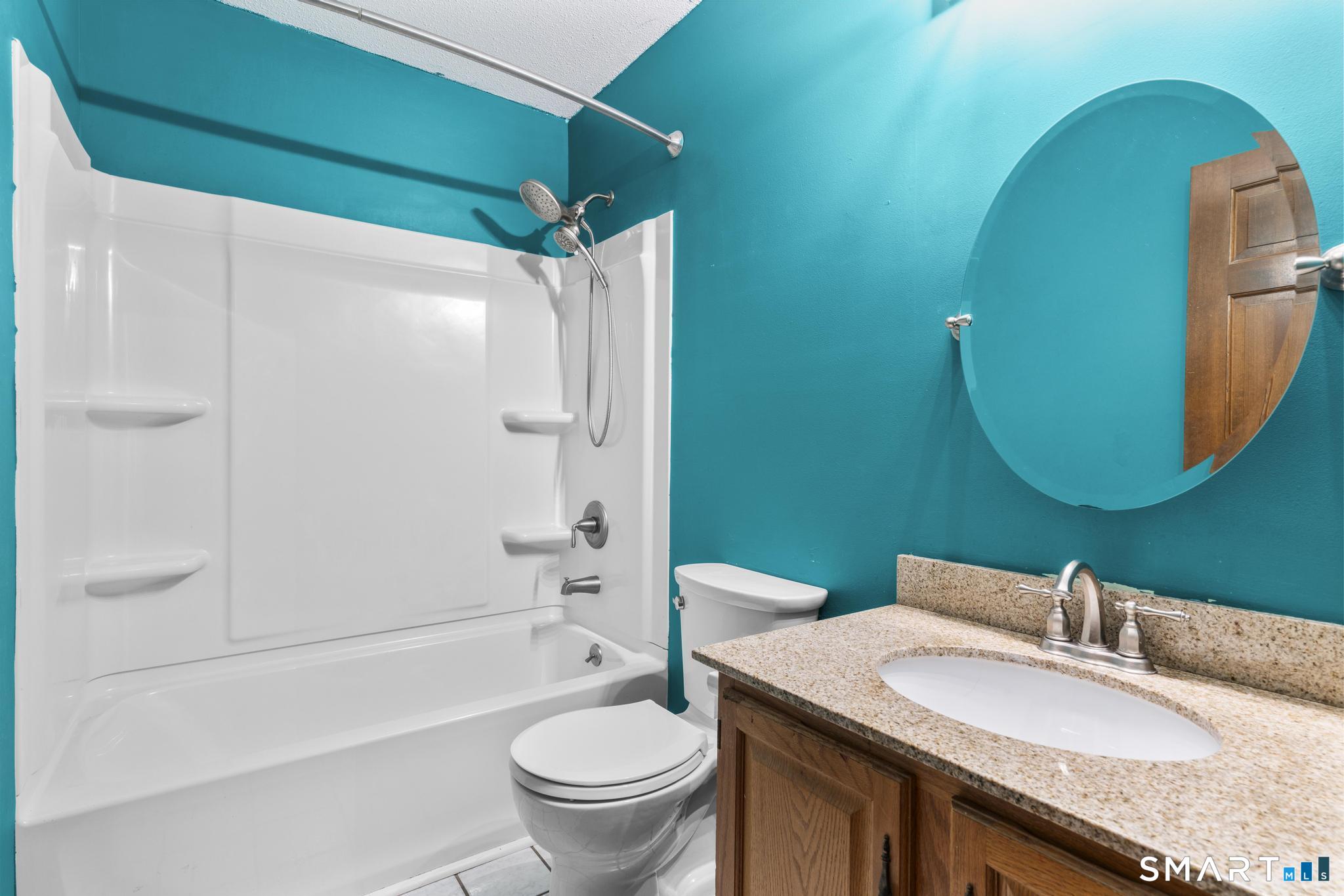 1655 North Colony Road, Unit 15 Meriden, CT 06450 - Photo 19 of 25 a bathroom with a granite countertop toilet sink and mirror