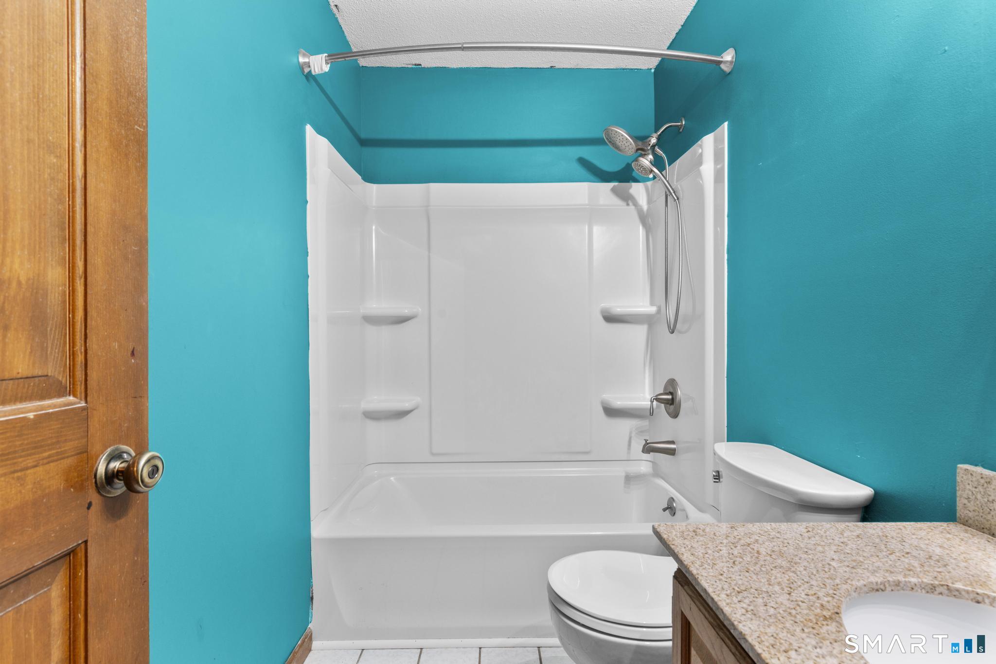 1655 North Colony Road, Unit 15 Meriden, CT 06450 - Photo 20 of 25 a bathroom with a toilet and a tub