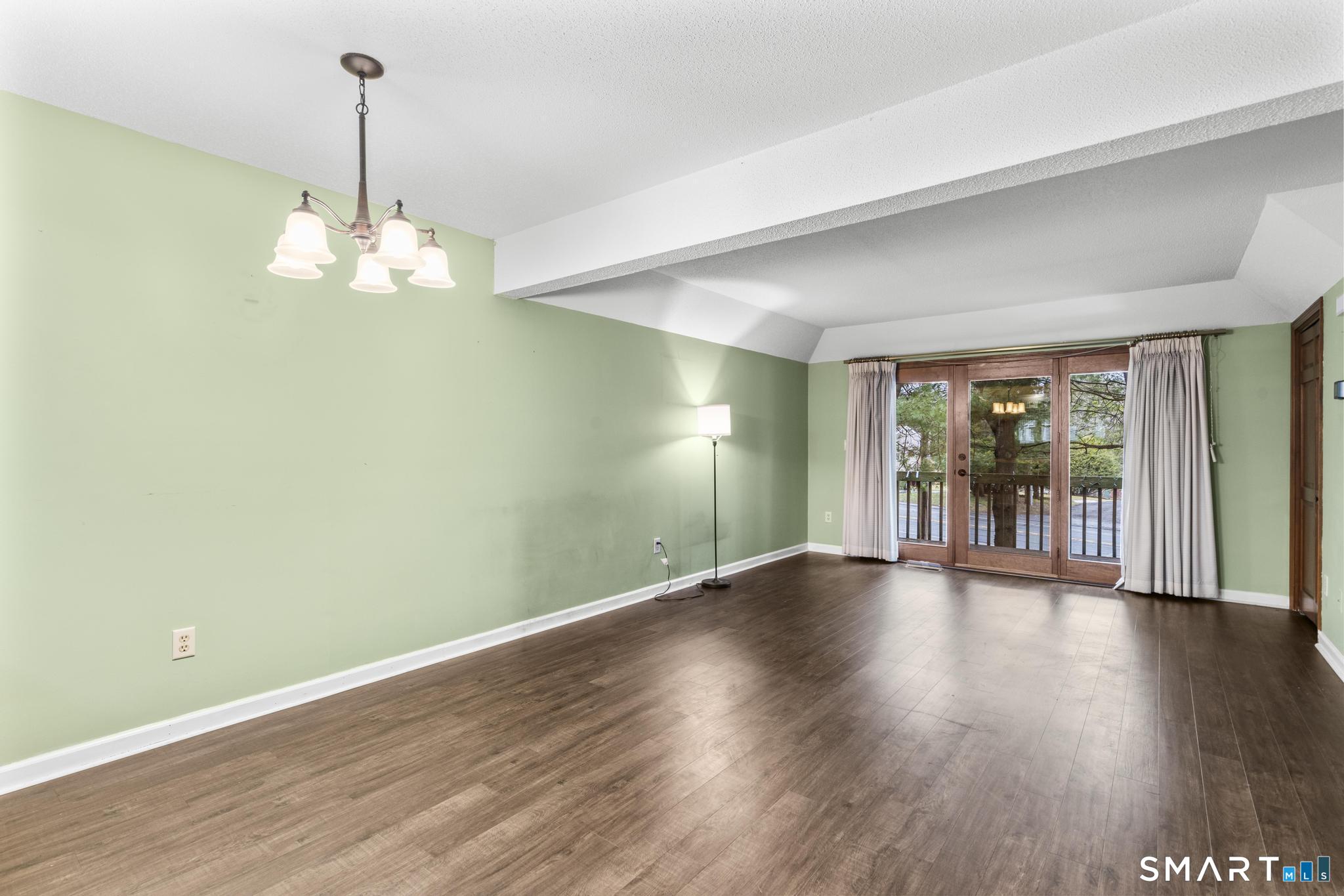 1655 North Colony Road, Unit 15 Meriden, CT 06450 - Photo 2 of 25 a view of an empty room with wooden floor and a window