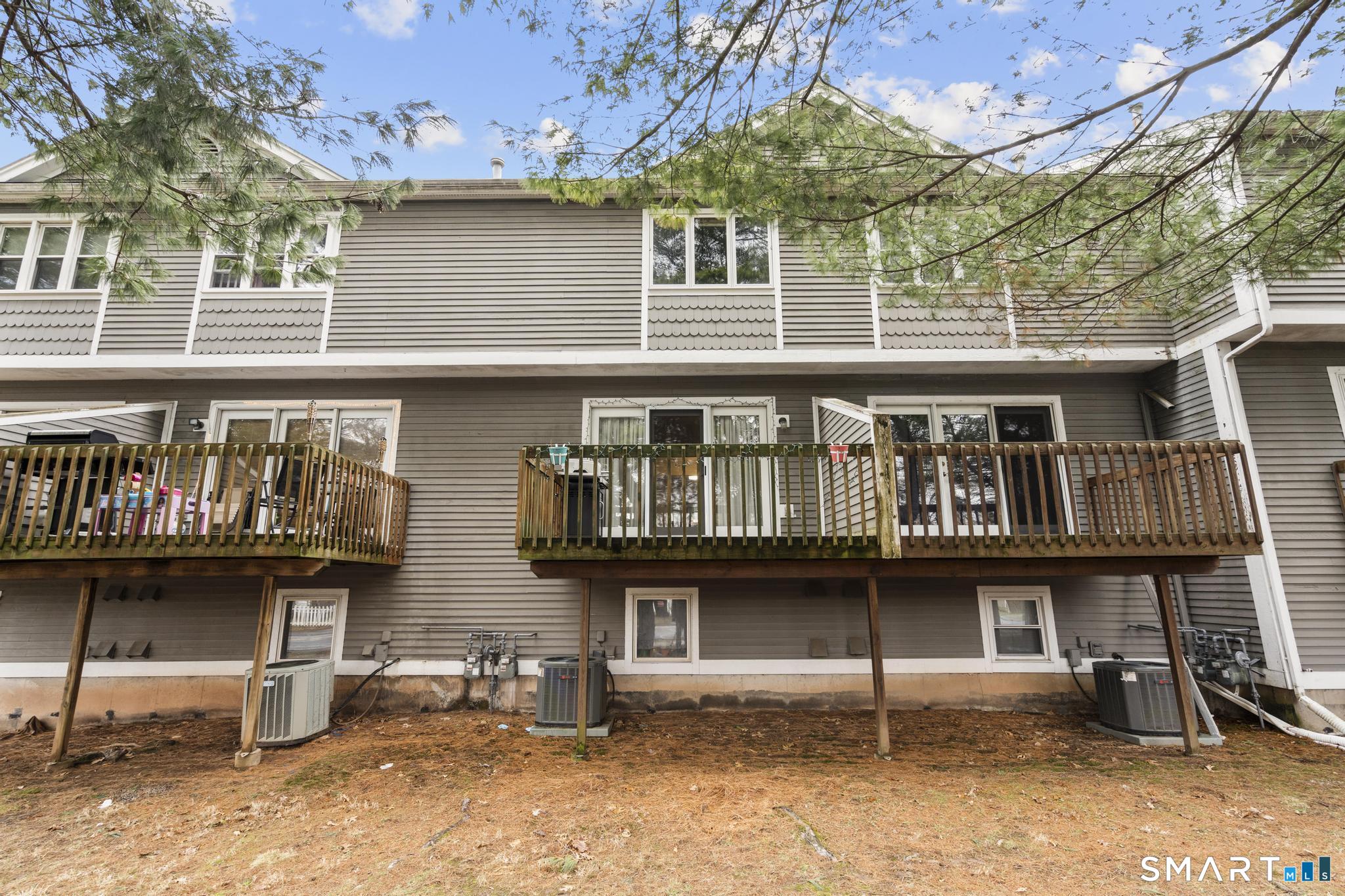 1655 North Colony Road, Unit 15 Meriden, CT 06450 - Photo 23 of 25 a view of a house with wooden deck and furniture