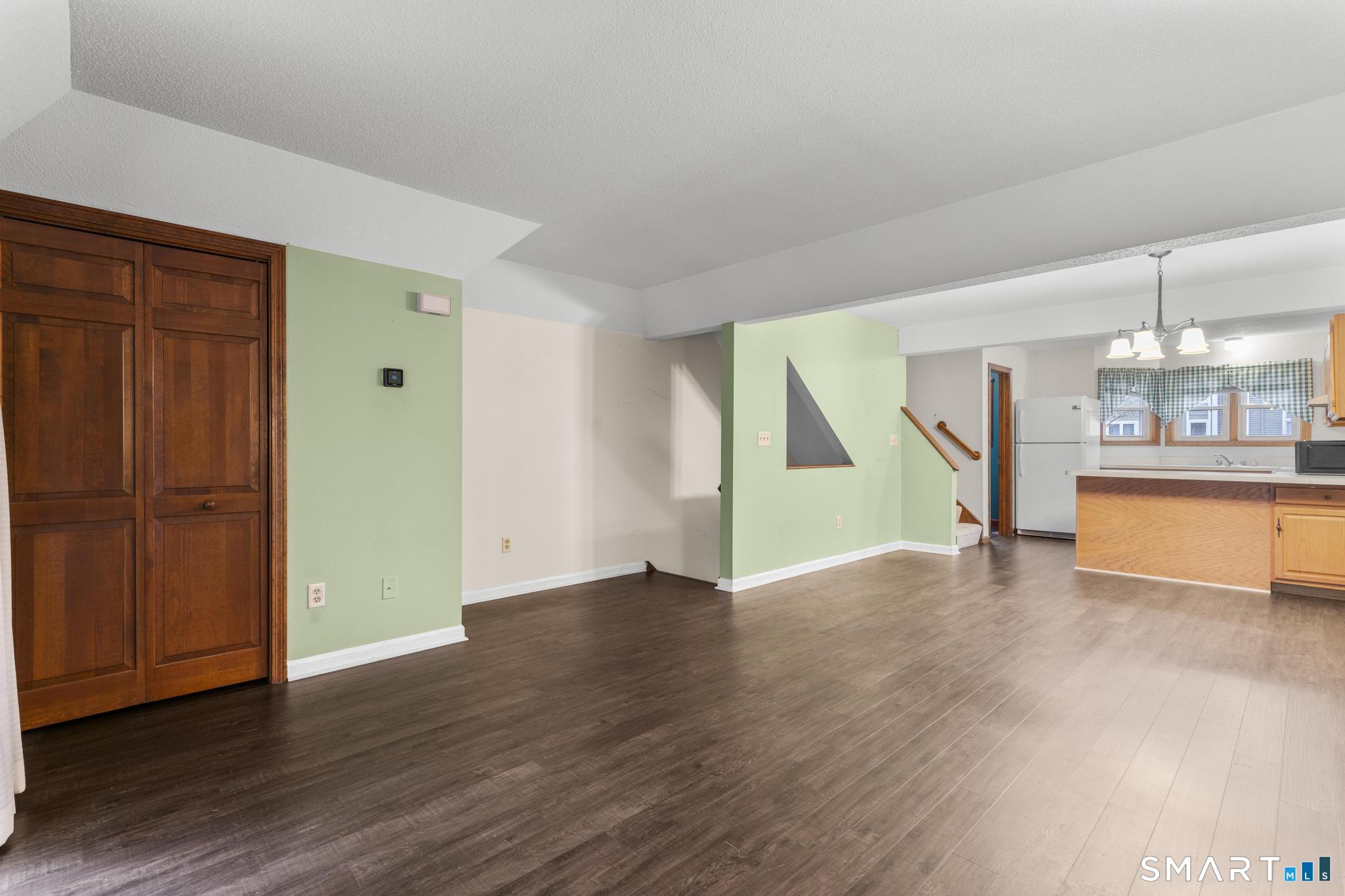 1655 North Colony Road, Unit 15 Meriden, CT 06450 - Photo 4 of 25 an empty room with wooden floor and windows