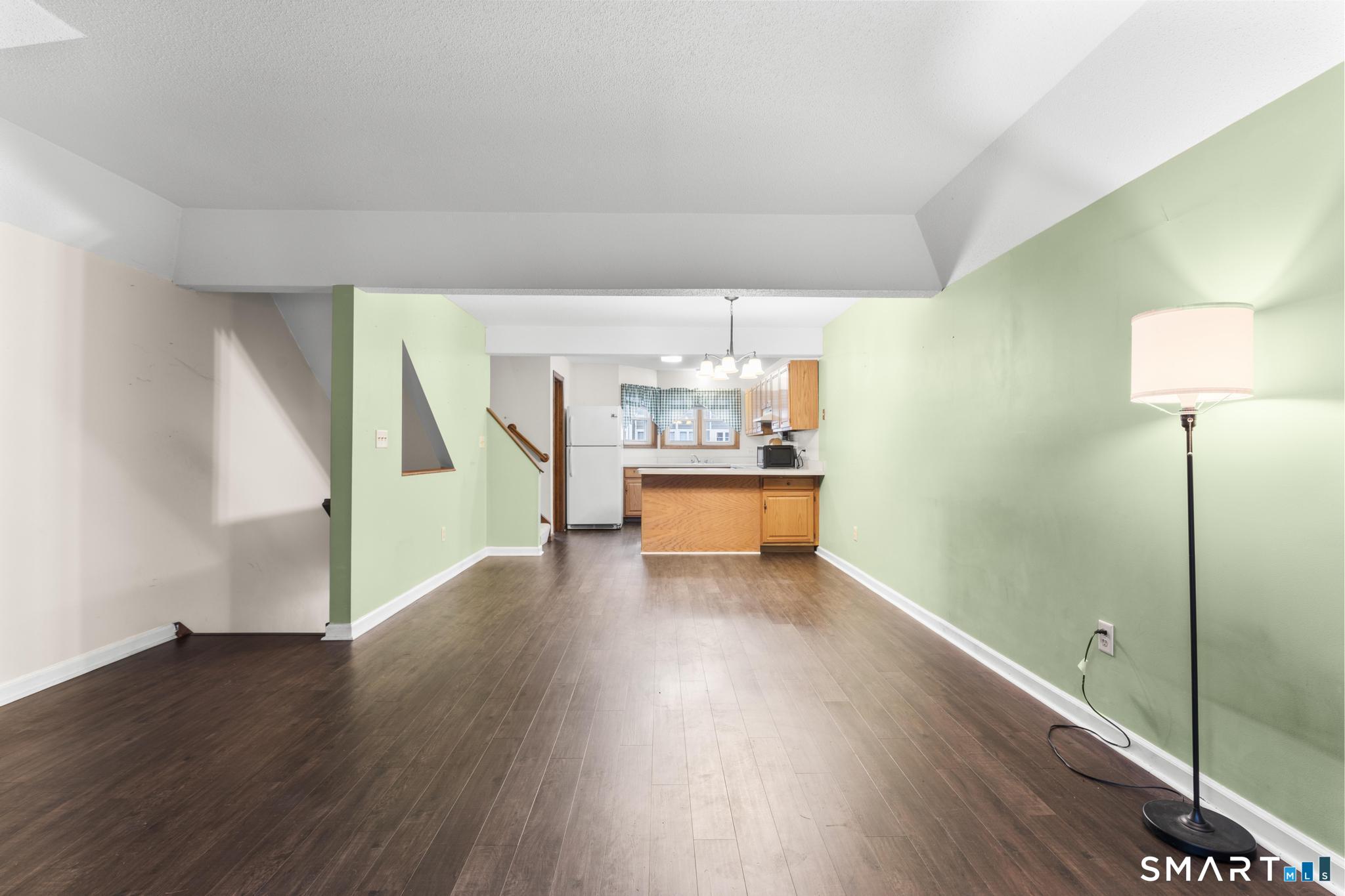 1655 North Colony Road, Unit 15 Meriden, CT 06450 - Photo 5 of 25 a view of a room with wooden floor fireplace and bathroom