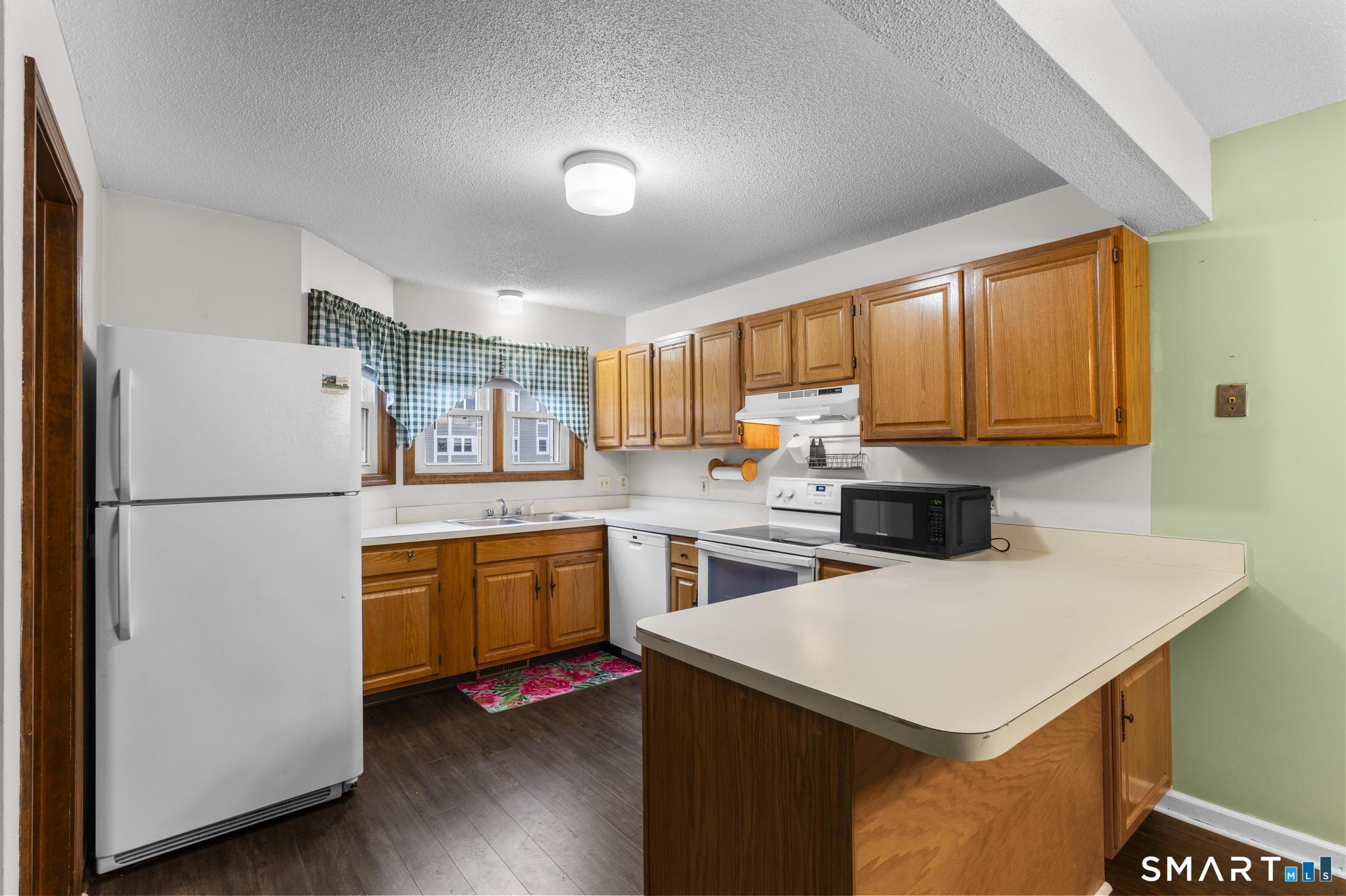 1655 North Colony Road, Unit 15 Meriden, CT 06450 - Photo 8 of 25 a kitchen with a refrigerator a stove a sink dishwasher and a refrigerator