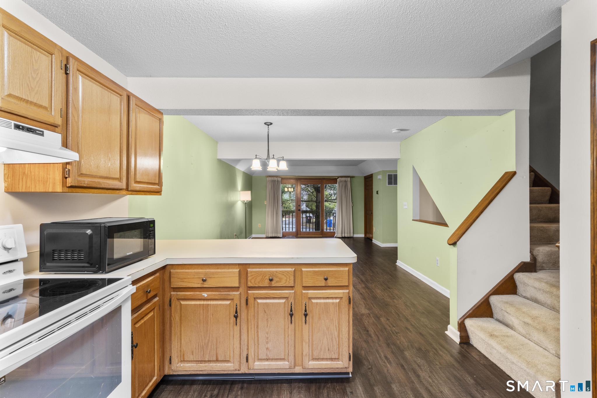 1655 North Colony Road, Unit 15 Meriden, CT 06450 - Photo 10 of 25 a kitchen with stainless steel appliances granite countertop a stove and cabinets