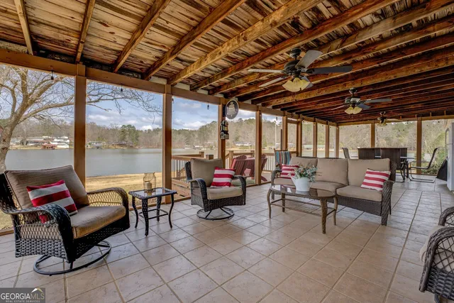 a dining room with furniture a rug and wooden floor