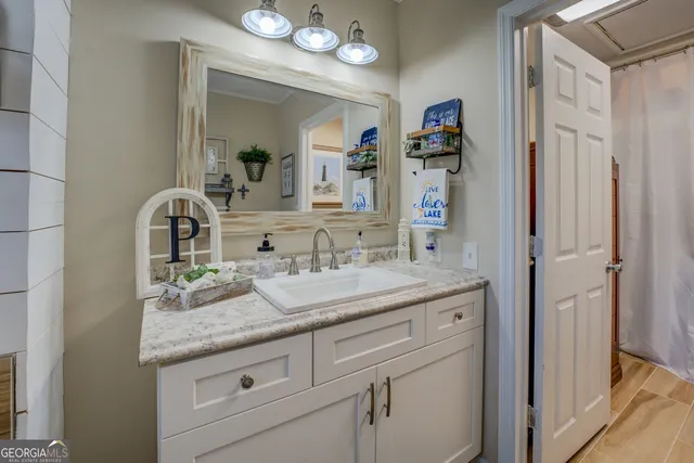 a view of swimming pool with outdoor seating and trees in the background