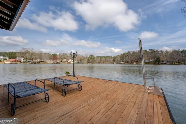 a living room with furniture and floor to ceiling window
