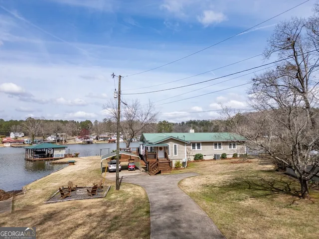 a view of a house with wooden fence