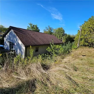 a view of a house with a yard and plants
