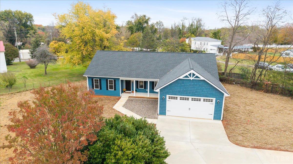 a aerial view of a house with a yard and a garage