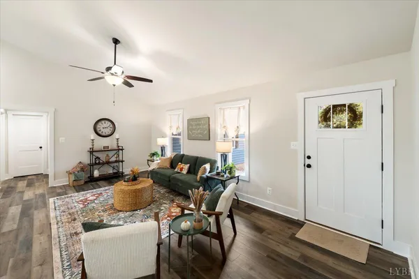 a living room with furniture a fireplace and a table