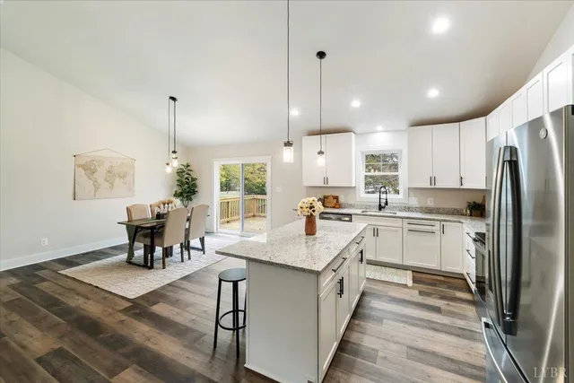a kitchen with stainless steel appliances granite countertop a stove a sink and a microwave