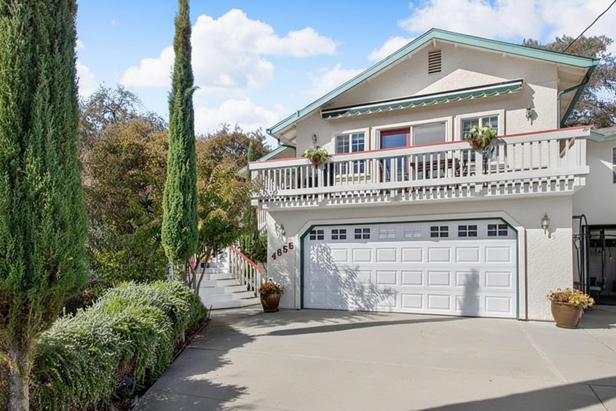 a front view of a house with a garden