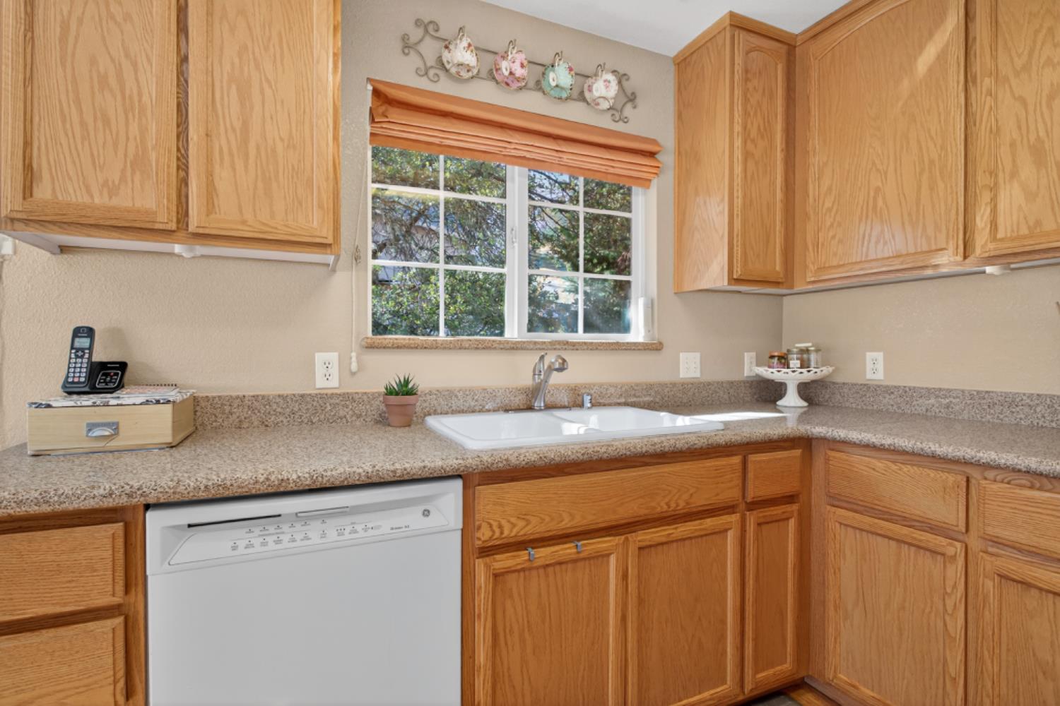 4856 Kiva Drive Copperopolis, CA 95228 - Photo 15 of 61 a kitchen with stainless steel appliances granite countertop white cabinets sink and window