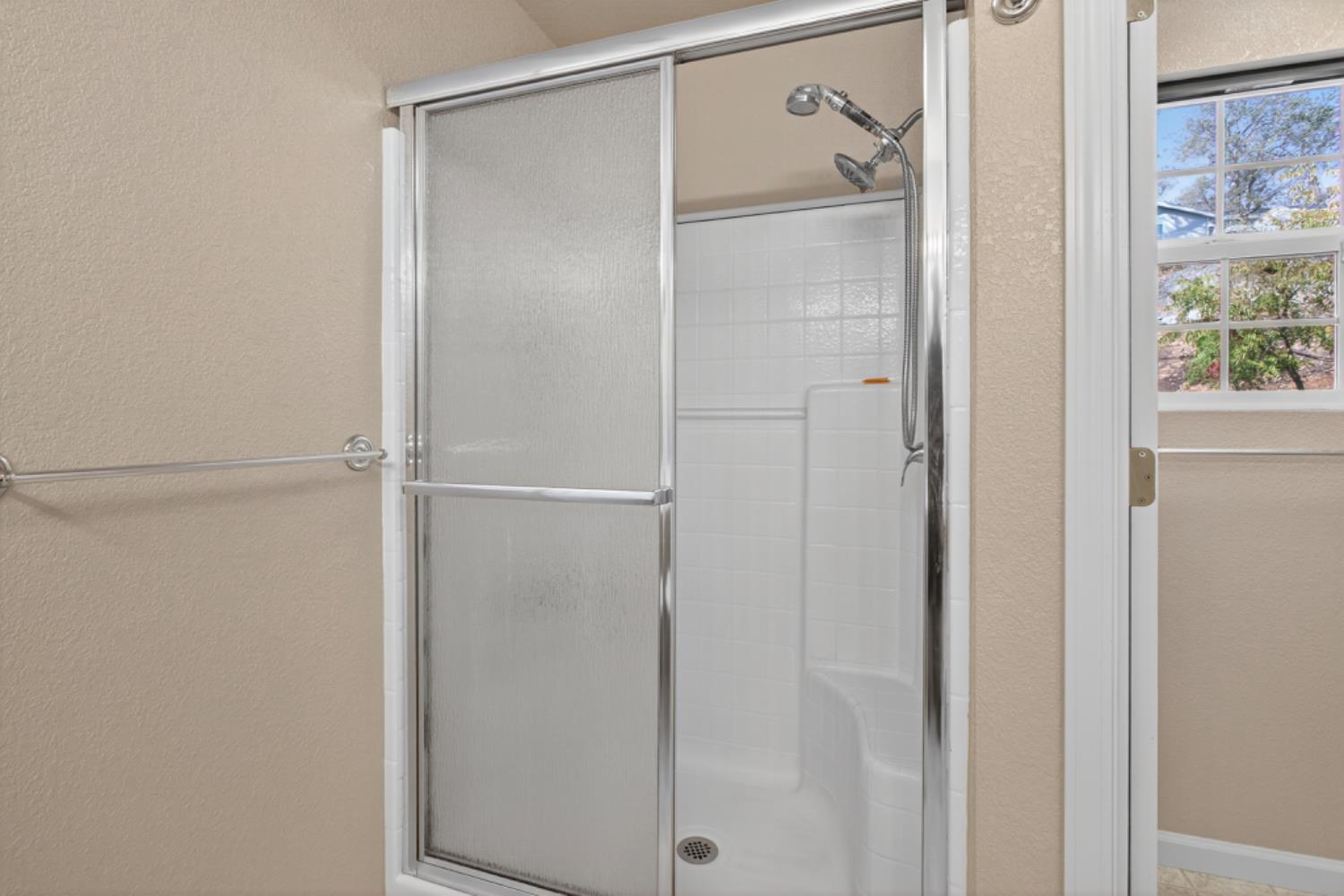 4856 Kiva Drive Copperopolis, CA 95228 - Photo 24 of 61 a bathroom with a glass shower door