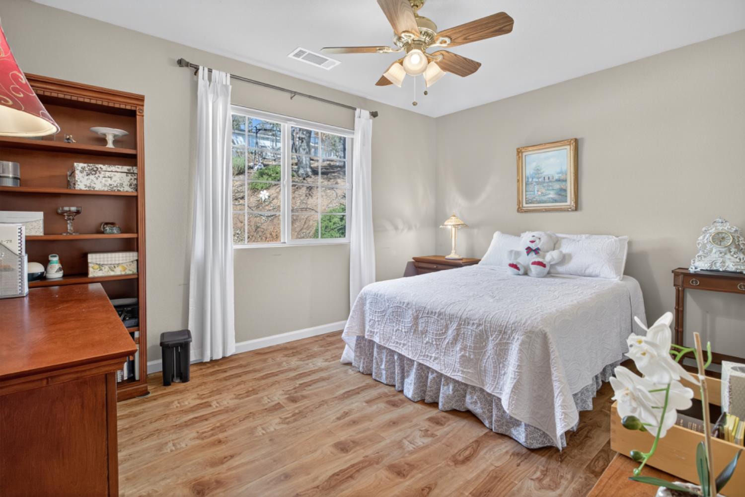 4856 Kiva Drive Copperopolis, CA 95228 - Photo 27 of 61 a spacious bedroom with a bed and a chandelier