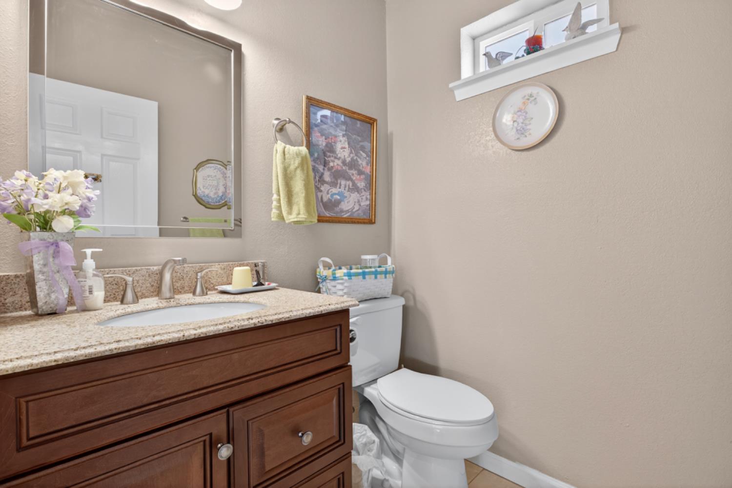 4856 Kiva Drive Copperopolis, CA 95228 - Photo 39 of 61 a bathroom with a granite countertop toilet sink and mirror